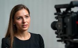 Person being interviewed with a camera filming them